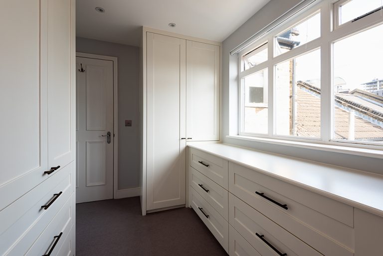 Built-in corner wardrobe in hallway. Designed and installed by local carpenters at Bespoke Carpentry London.