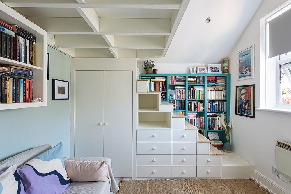 Built in cabin bed on a mezzanine with wardrobe, cupboards, bookcase, bed and storage space.