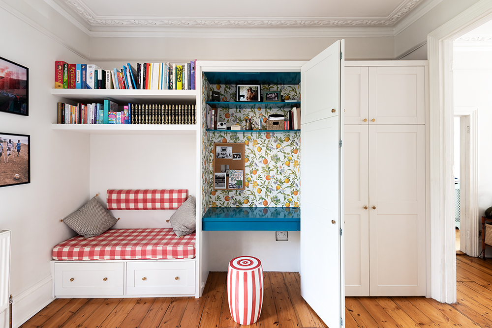 Built-in multifunctional wardrobe with desk, seating area and bookcase. Designed and installed by Bespoke Carpentry London.