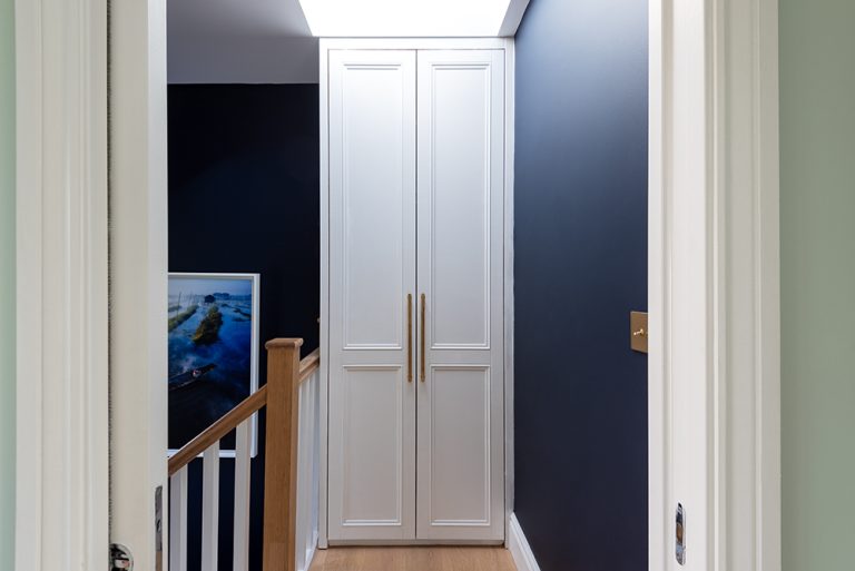 Fitted hallway wardrobe with 2 doors. Designed and installed by Bespoke Carpentry London.