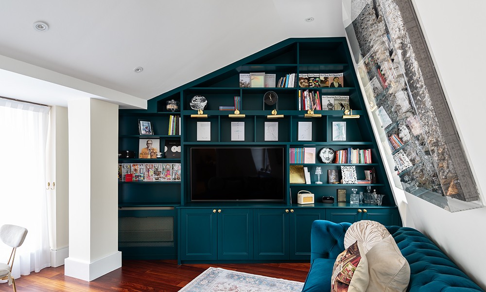 Large green built in cupboard with TV unit. Designed and installed by local joiners at Bespoke Carpentry London.