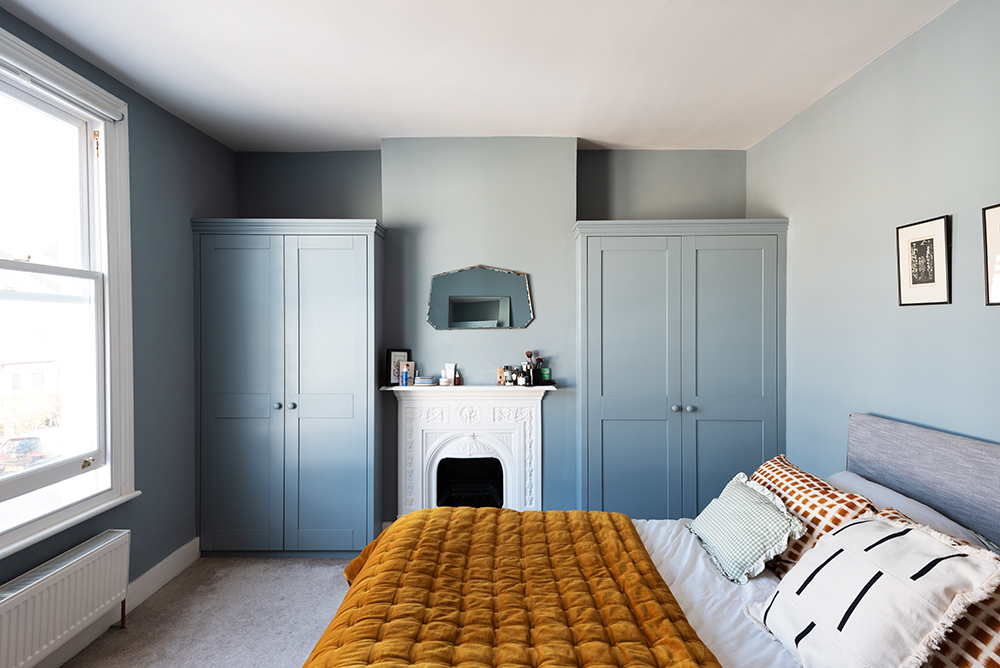 Pastel blue bespoke wardrobes in bedroom