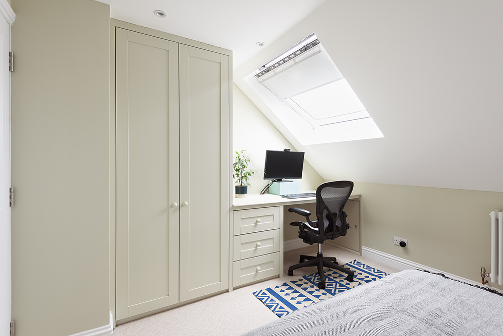 Built-in wardrobe with desk in loft space. Designed and installed by Bespoke Carpentry London