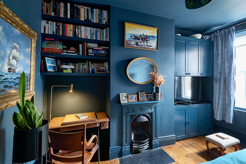 Blue alcove cupboards next to fireplace. Built by carpenters at Bespoke Carpentry London