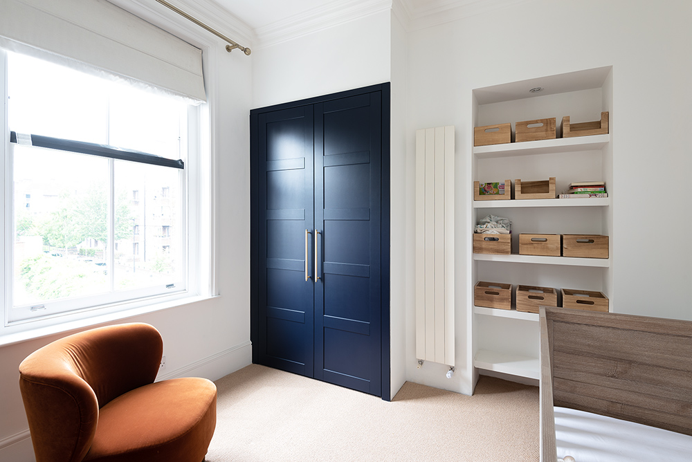 Blue fitted alcove wardrobe in bedroom