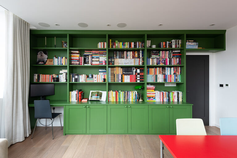 Built in green cupboard with shelving units in living room