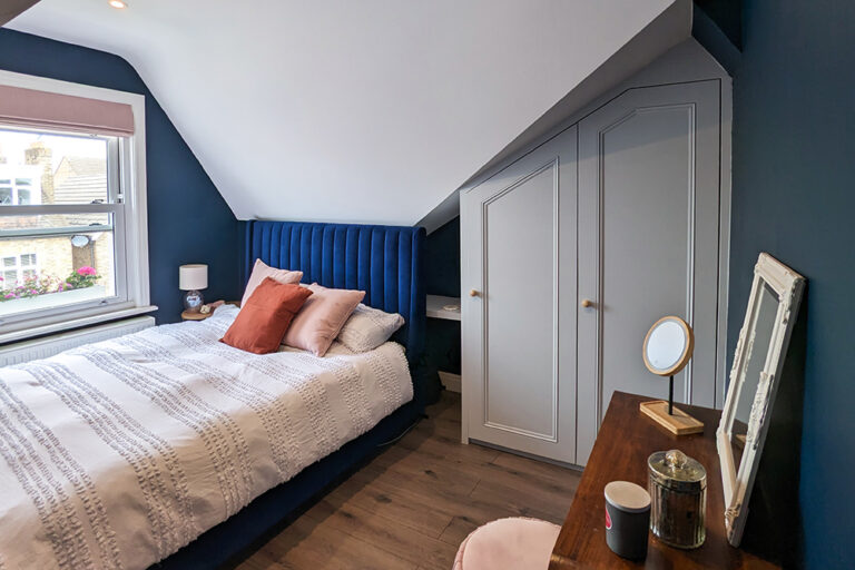 Slanted loft wardrobe in bedroom. Built and designed by Bespoke Carpentry London