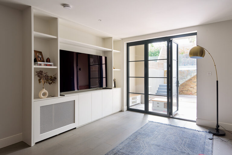 Fitted TV Unit in Living Room with cupboards and shelving.