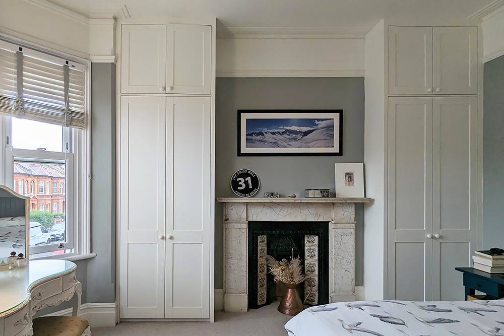 Fitted alcove wardrobes next to chimney breast