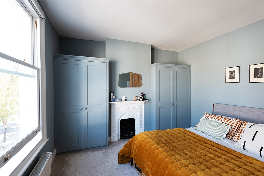 Fitted blue alcove wardrobes in bedroom