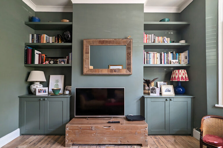 Green alcove cupboards in living room