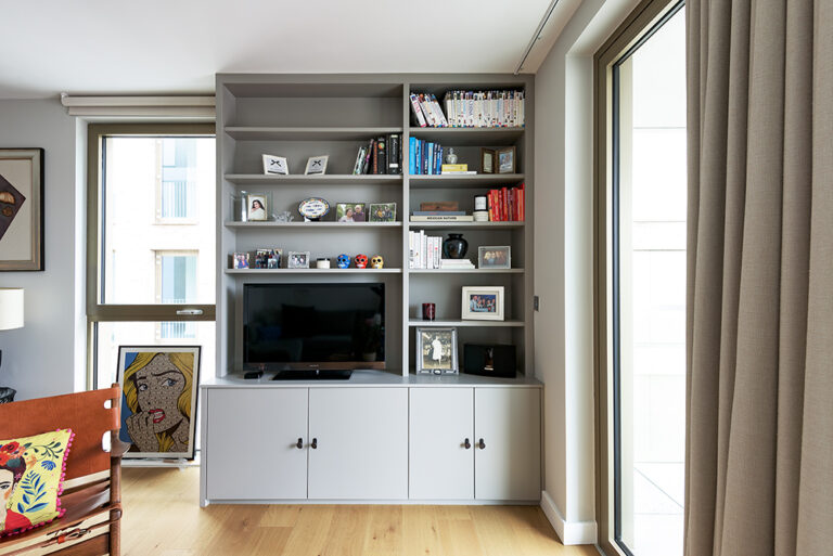 Grey cupboard with built-in shelves for books and TV unit