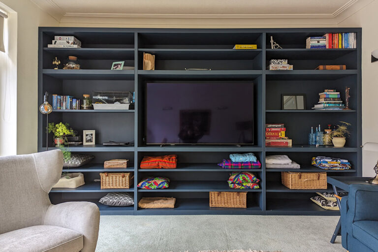 Large wall to wall media unit with lots of shelving to store books and personal belongings.