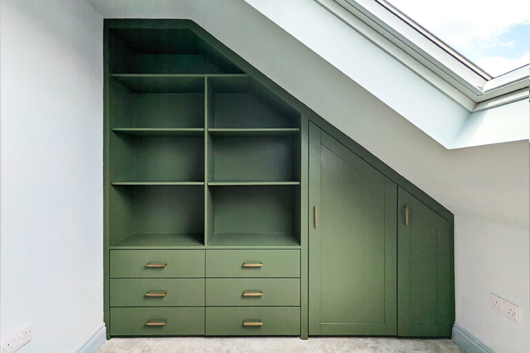 Built-in slanted green loft wardrobe.