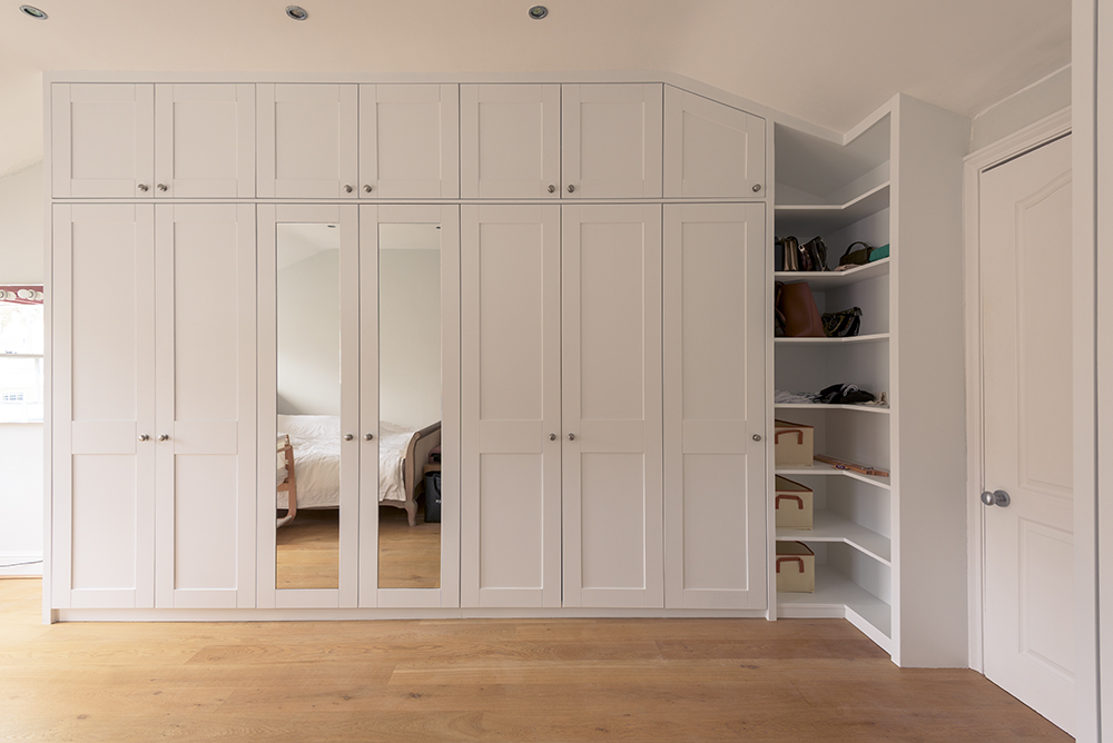 Large modern wardrobe fitted into corner space