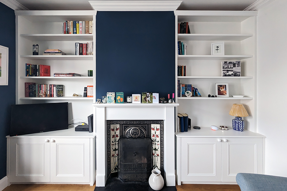 Two Alcove Cabinets either side of fireplace to store books and TV unit