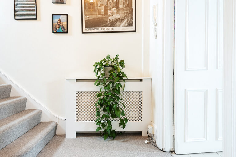 White radiator cover. Designed and installed by carpenters at Bespoke Carpentry London