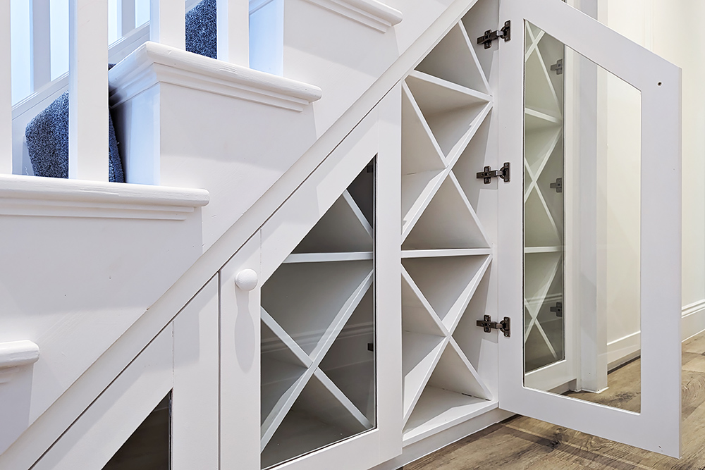 White wine rack fitted under stairs storage unit