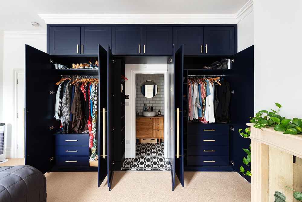 Built-in wardrobe with hidden door to bathroom. Designed and installed by Bespoke Carpentry London