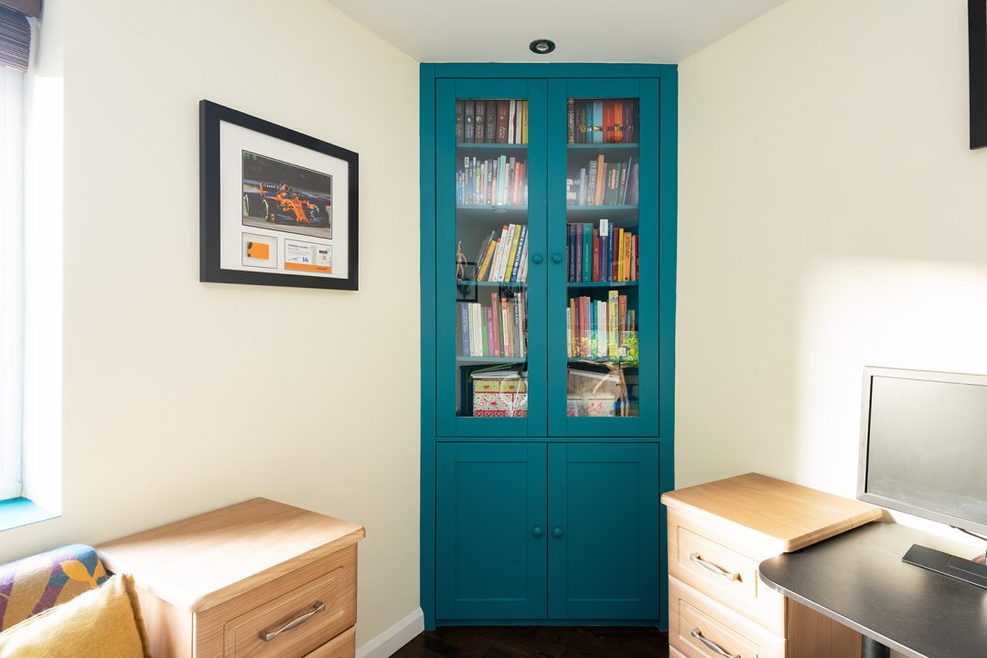 After picture of a built-in corner cupboard to store books