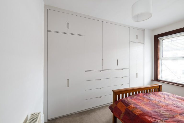 After picture of large built in wall to wall wardrobe