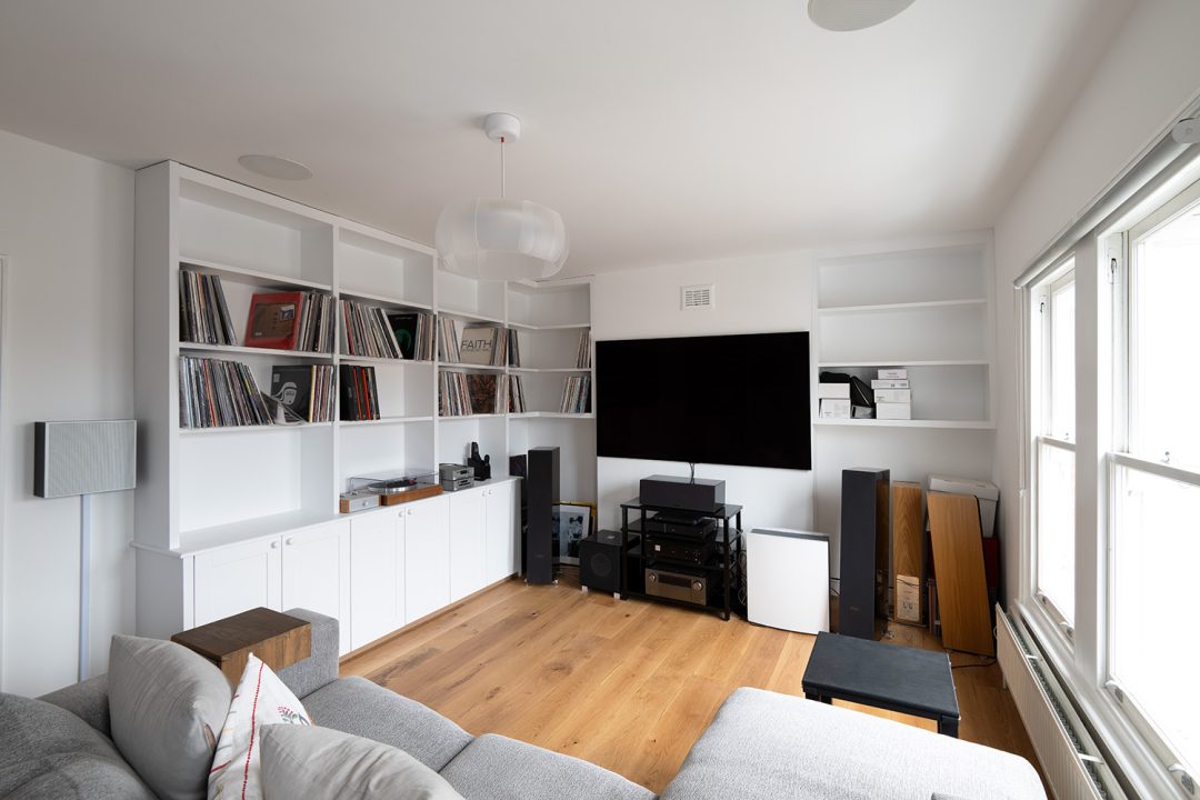 White alcove cupboard in alcove space to store vinyl records and TV