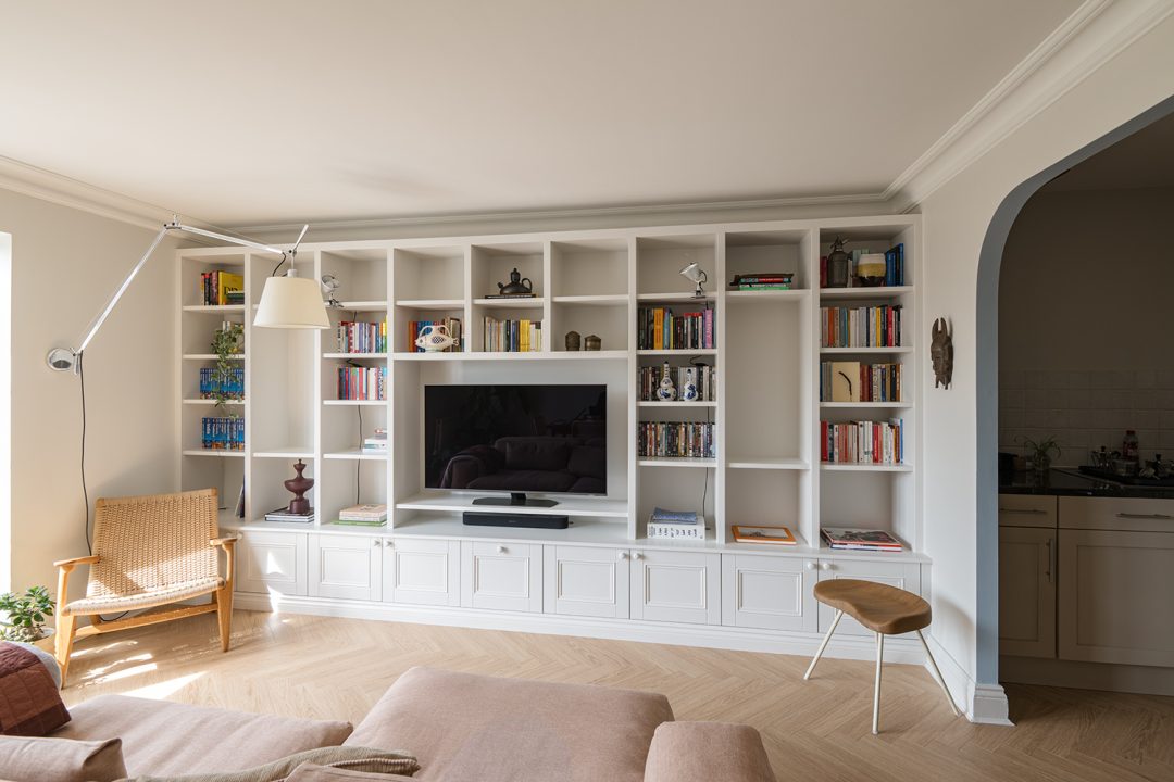 Large wall to wall built in TV unit with storage cupboards and shelving unit.