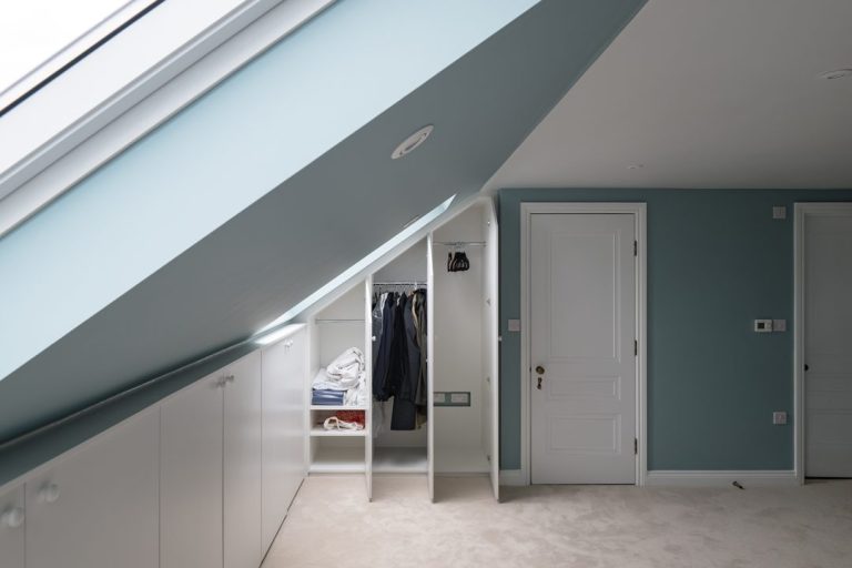 Bespoke loft wardrobe with internal view of clothes rack