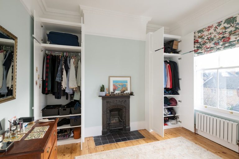 Bespoke alcove wardrobe with inside view, shelving and clothes rack. Designed and installed by carpenters at Bespoke Carpentry London