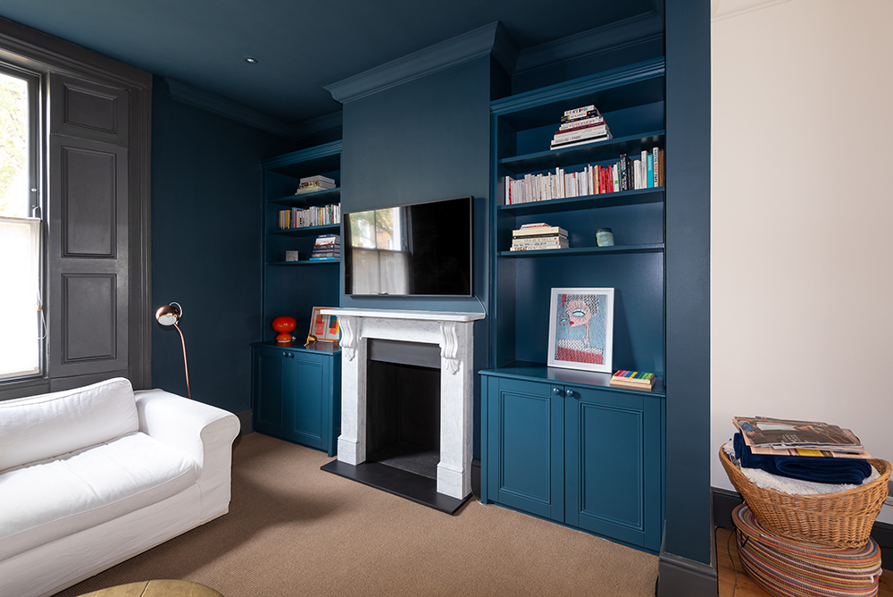 Blue cupboard with alcove floating shelves