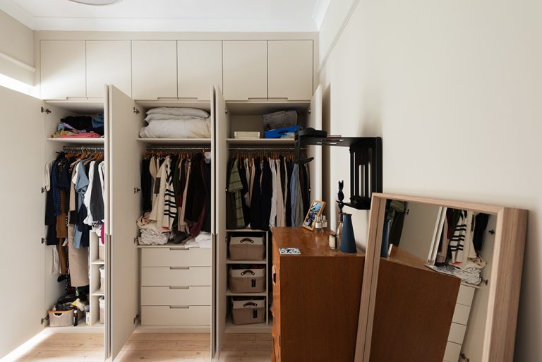 Fitted wardrobe with view of drawers, shelving and clothes racks