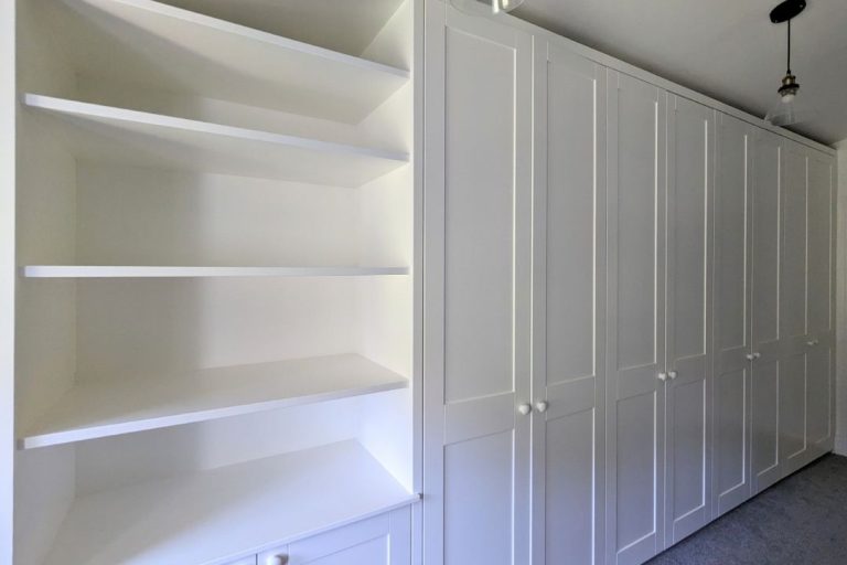 Wall to wall bespoke wardrobes with multiple doors.