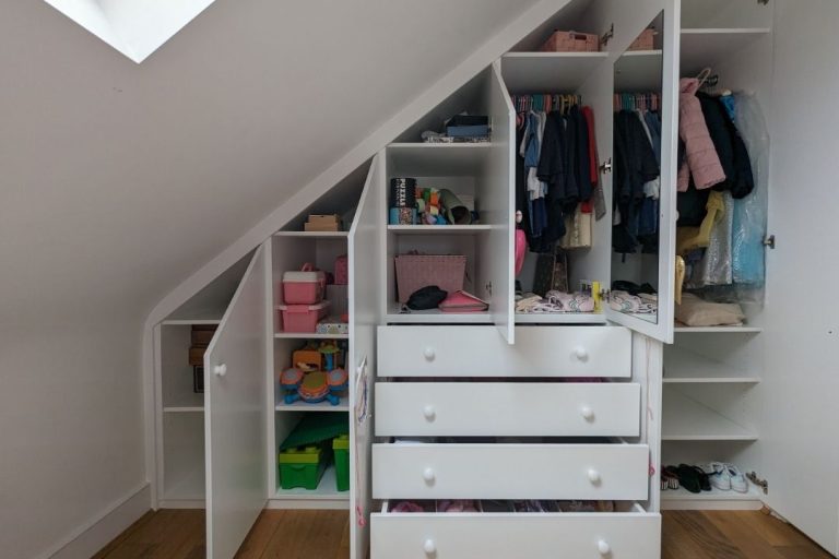 Inside a loft wardrobe for a kid's bedroom. Designed and installed by Bespoke Carpentry London.