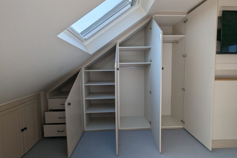 Inside view of a fitted loft wardrobe. Designed and installed by Bespoke Carpentry London.