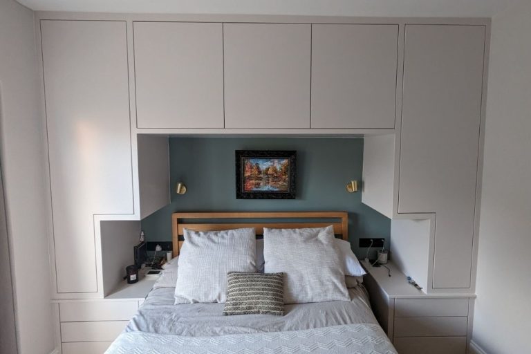 Custom made over the bed wardrobe. Designed and installed by Bespoke Carpentry London