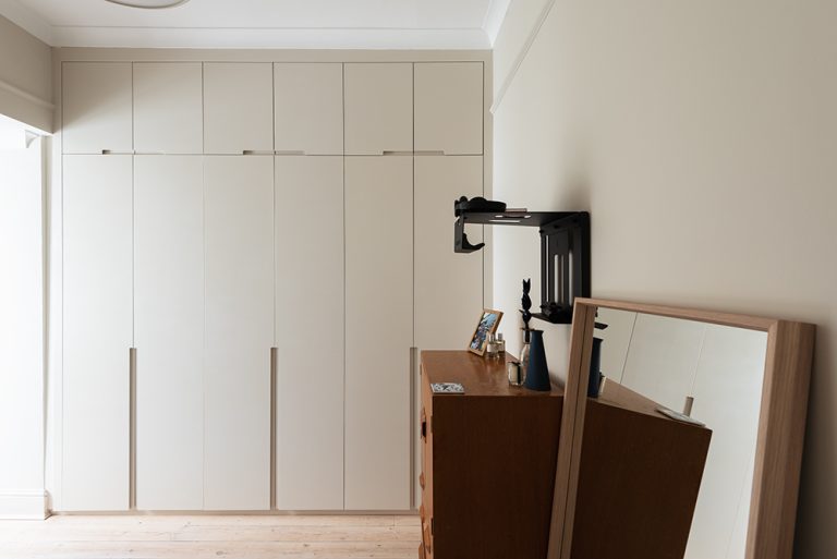 White bespoke wardrobe with 6 doors. Designed and installed by carpenters at Bespoke Carpentry London