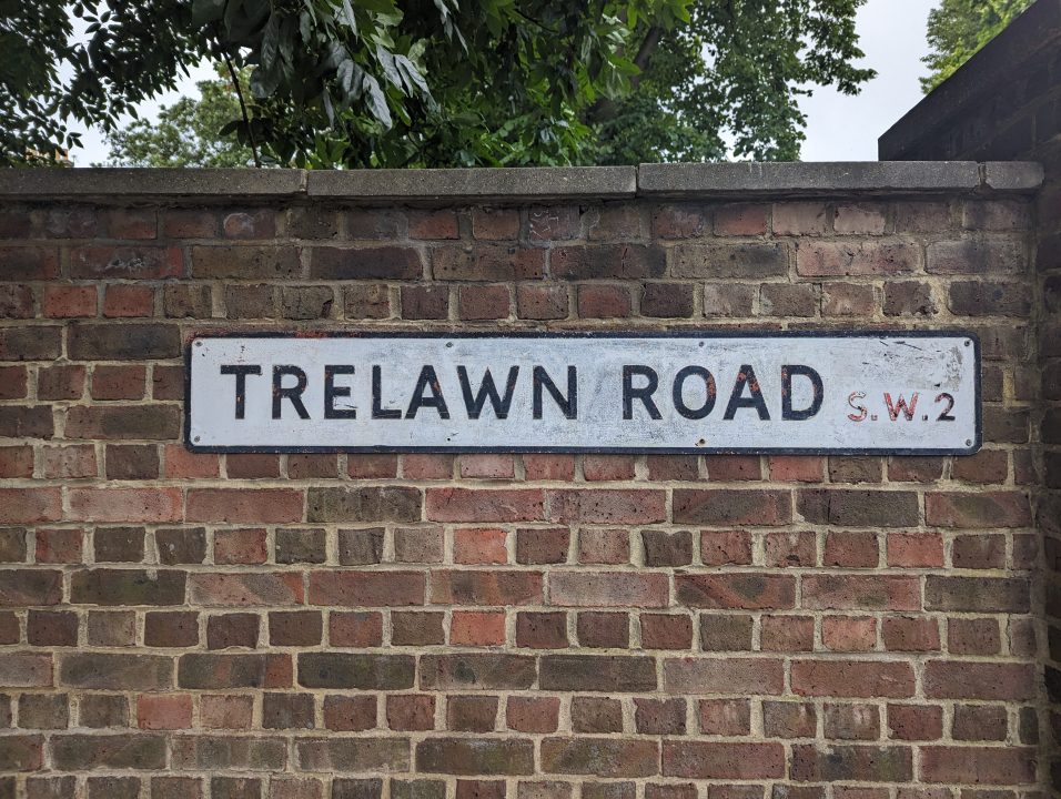 Street name on brick wall in Brixton called Trelawn Road