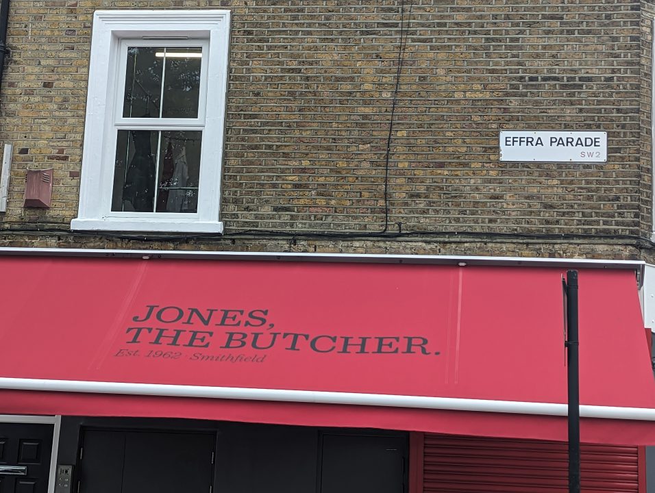 Street name on top of butchers in Brixton