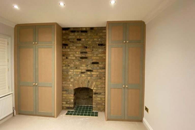 Alcove fitted wardrobes next to chimney