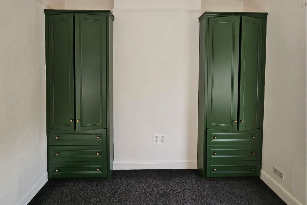 Fitted alcove wardrobes painted in green