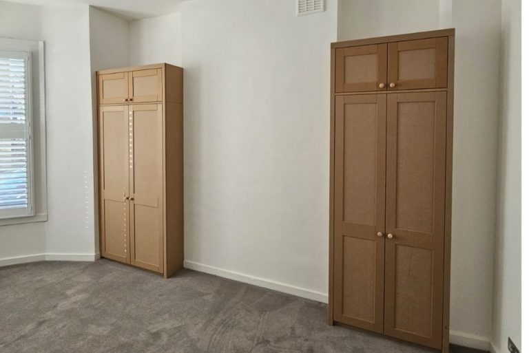 Two sets of alcove wardrobes on each side of wall