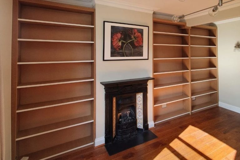 Fitted alcove shelving next to fireplace