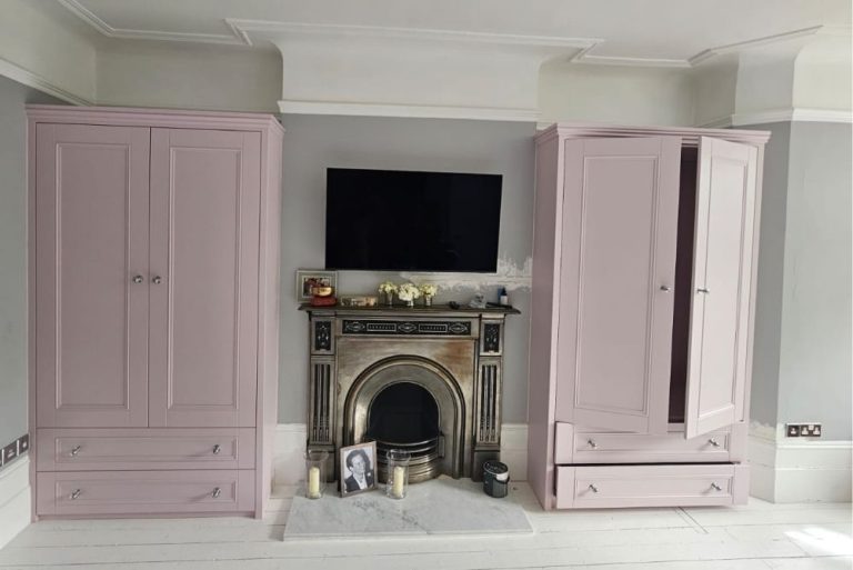 Pink fitted alcove wardrobes next to chimney