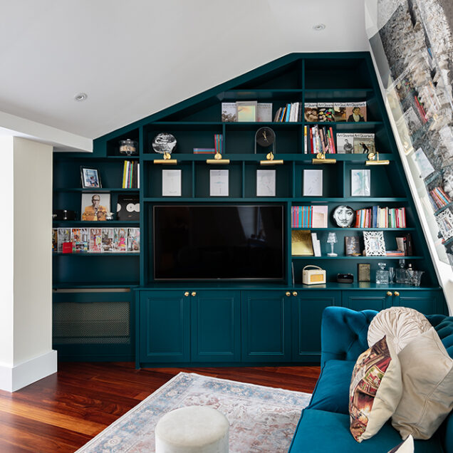 Large green built-in cupboard on a slanted wall in the living room.