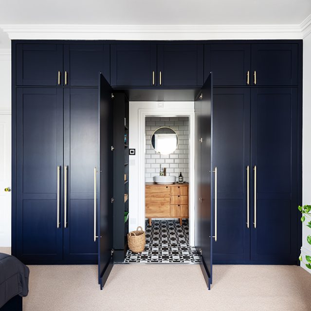 Built-in blue wardrobe. Designed by carpenters at Bespoke Carpentry London.