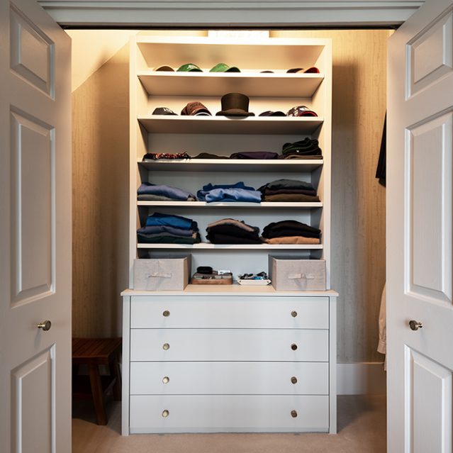 White built-in walk in wardrobe, made with MDF and hand-painted. Designed and installed by carpenters and joiners at Bespoke Carpentry London